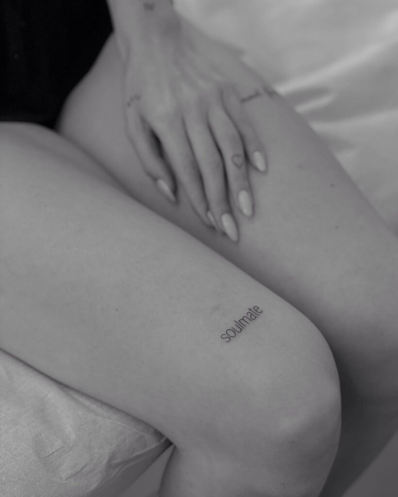 Minimalist soulmate lettering tattoo above the knee charm