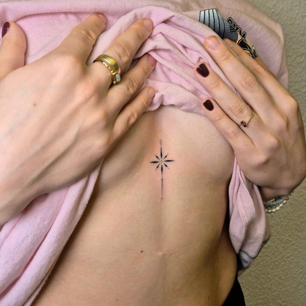 Minimalist star sternum tattoo representing guidance and inner strength
