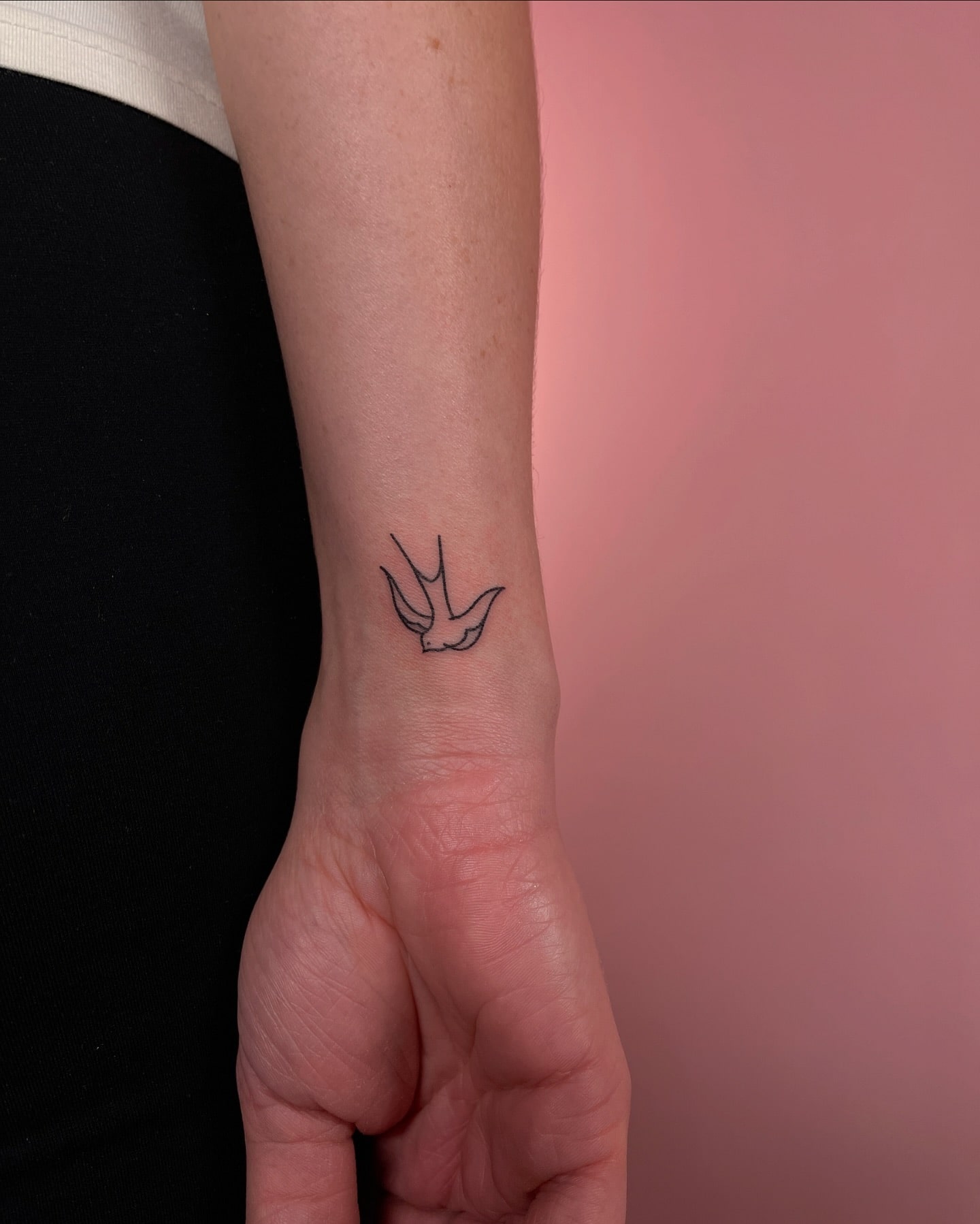 Minimalist Swallow Bird Tattoo on Wrist Representing Freedom & New Beginnings