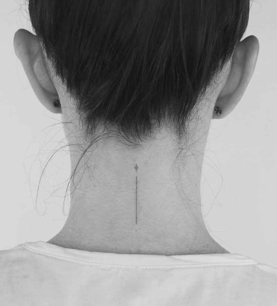 Minimalist vertical line and diamond tattoo on nape of the neck