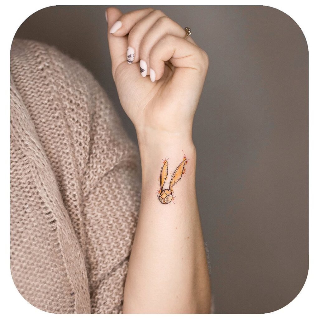 Minimalistic Golden Snitch Tattoo on Wrist for Girls