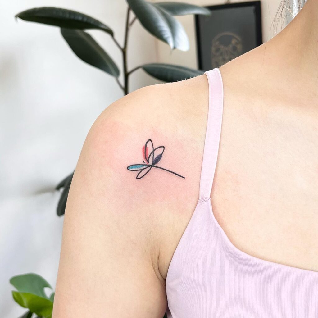 Modern Single-Line Dragonfly Tattoo with Playful Pops of Color on Shoulder