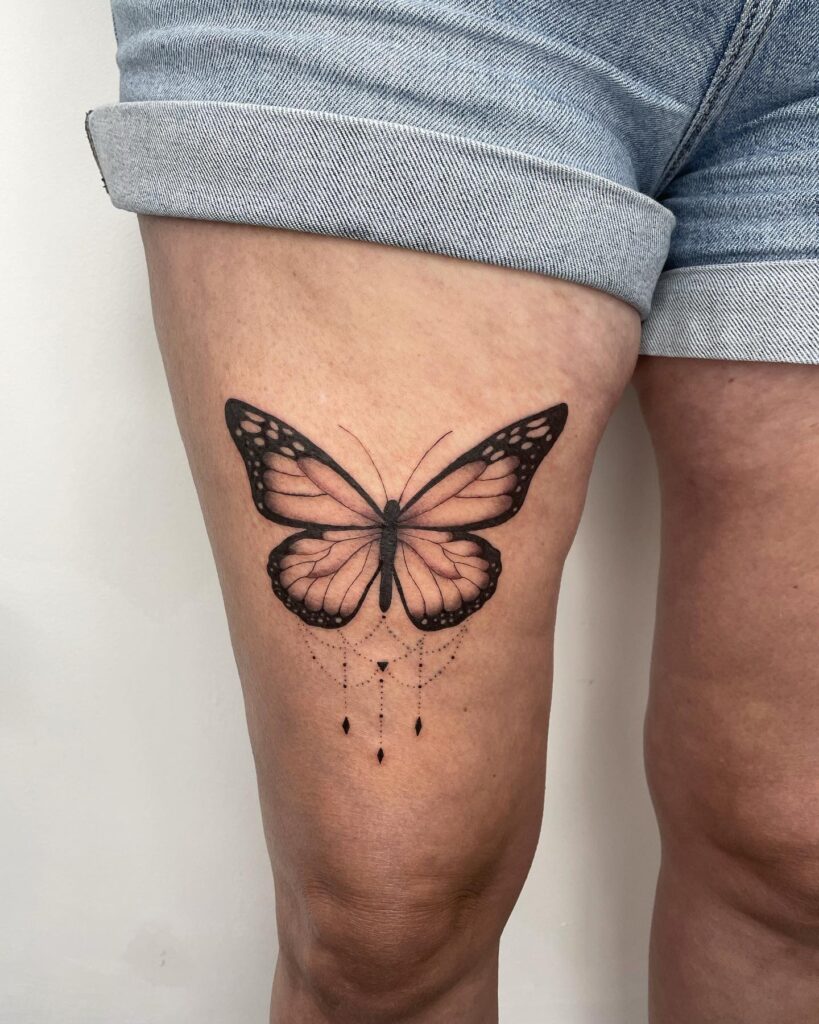Monarch majesty captivating butterfly tattoo designs on thigh