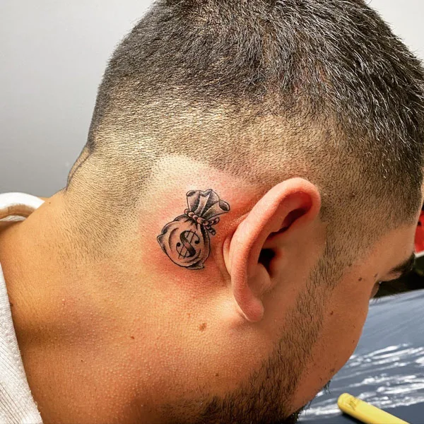Money bag tattoo behind ear