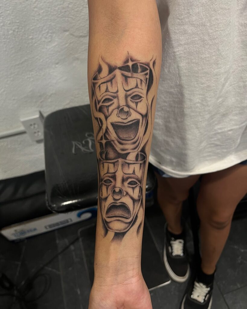 Monochromatic emotions black and grey laugh now cry later forearm tattoo
