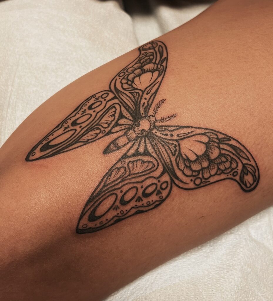 Monochrome floral butterfly moth grace on the thigh