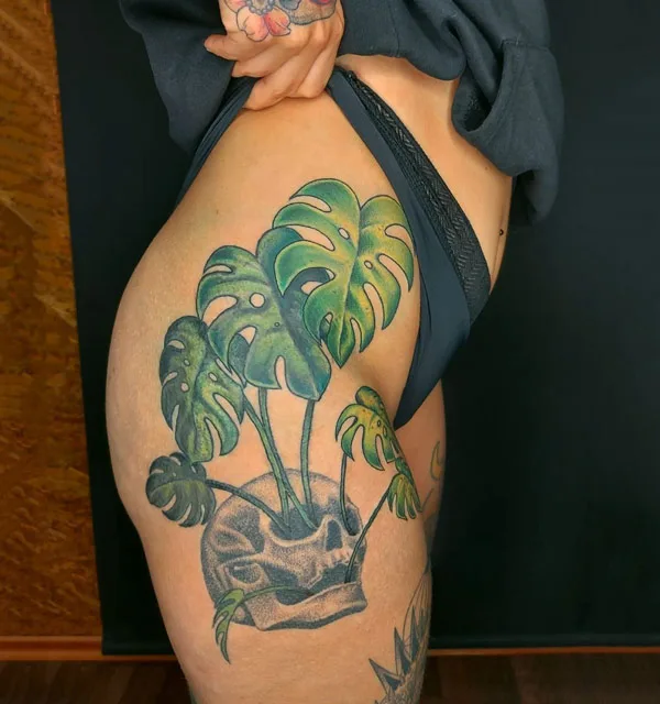 Monstera tattoo on thigh