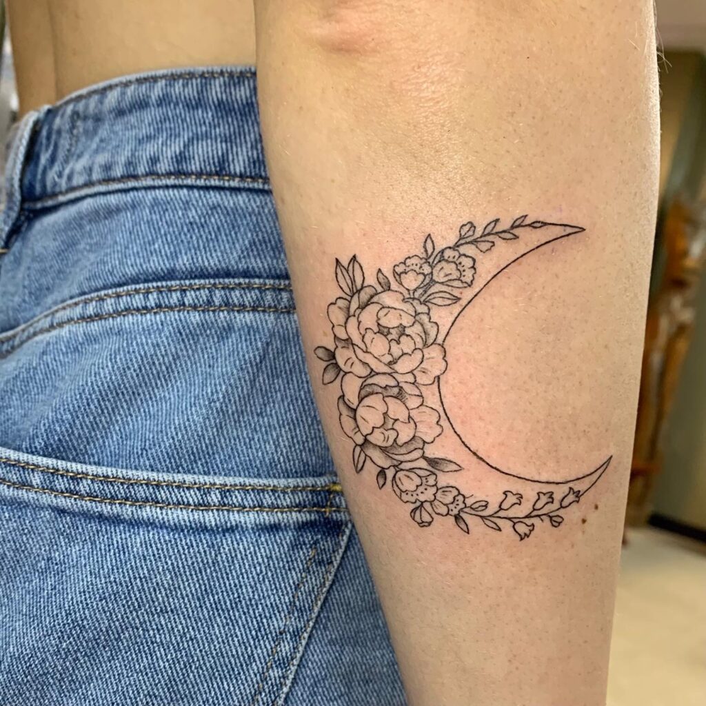 Moon and bluebell flower tattoo below the elbow subtle charm