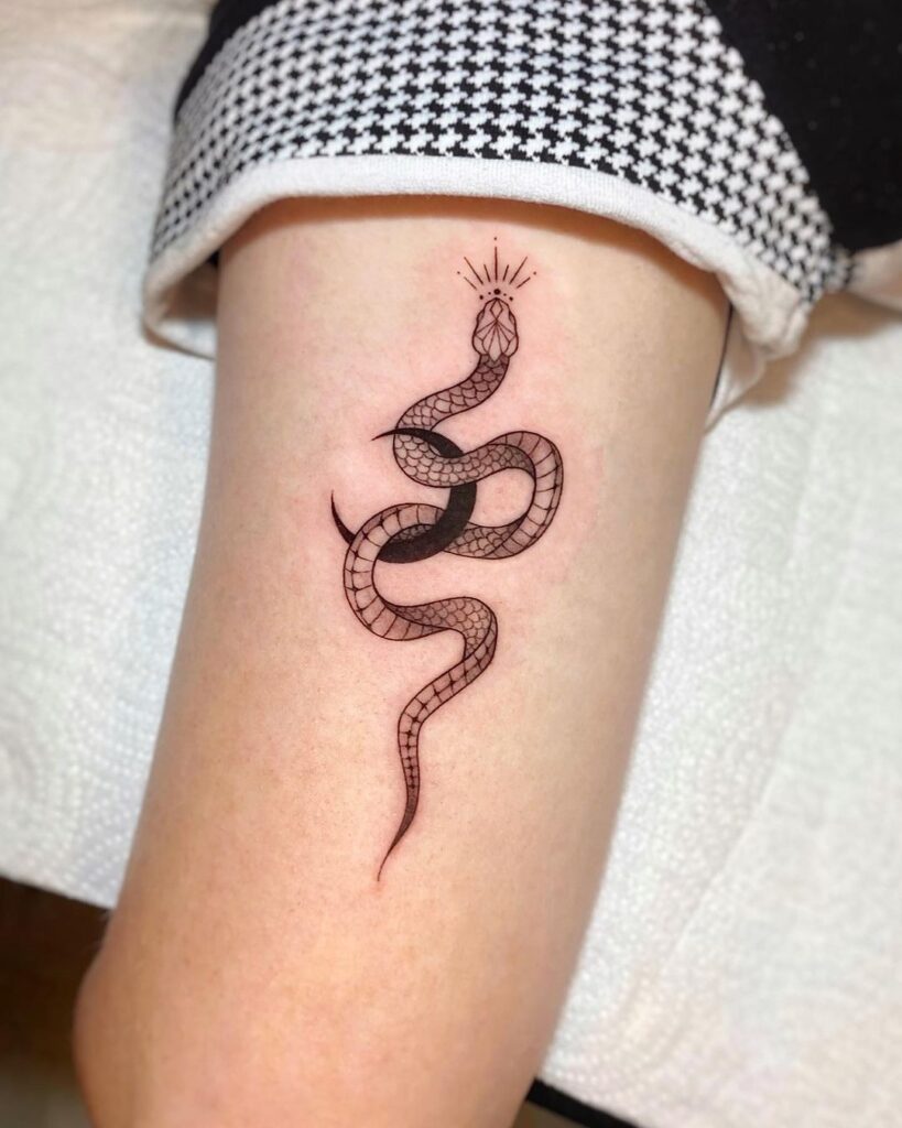 Moon and king cobra tattoo on the back of the arm minimalist serpent art