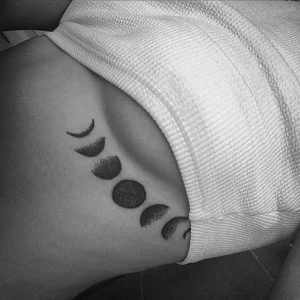 Moon phases tattoo under breast 1