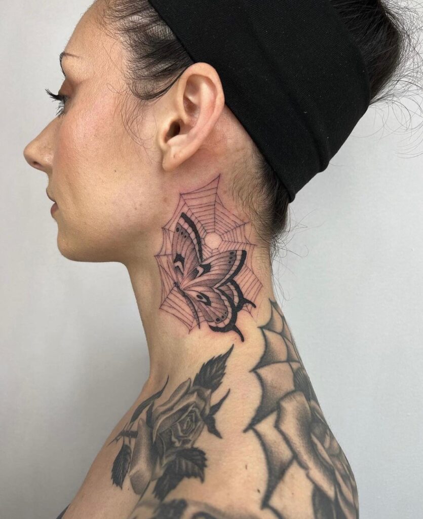 Moth in spider's web a fascinating ear and neck tattoo