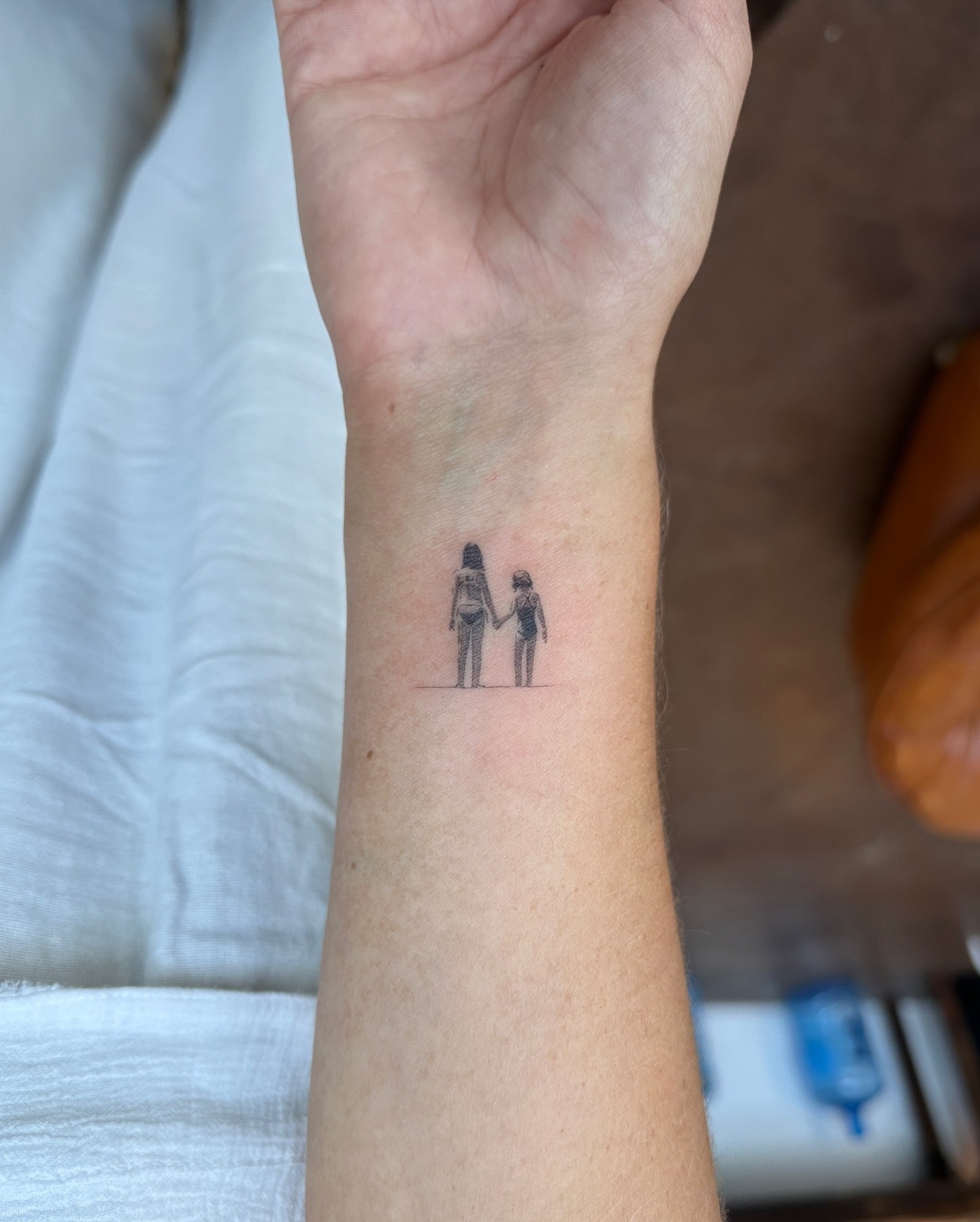 Mother and Child Holding Hands Tattoo Minimalist and Sentimental Design