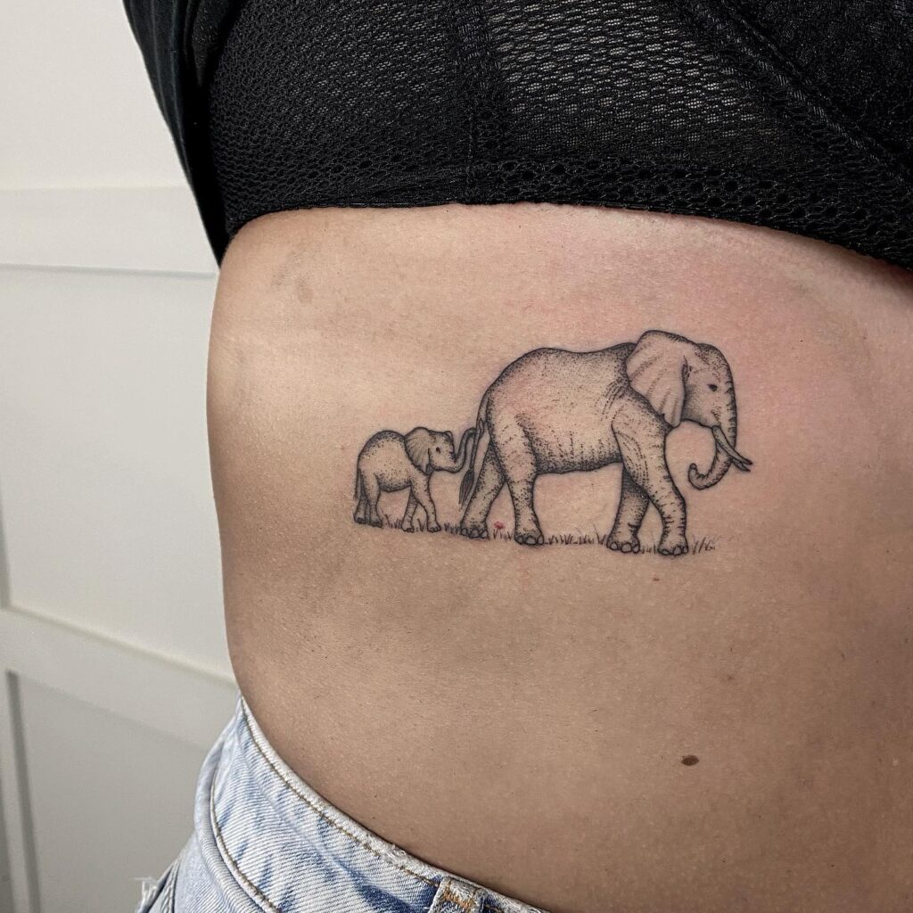 Mother elephant and baby elephant tattoo on the rib: graceful and shaded family tattoo