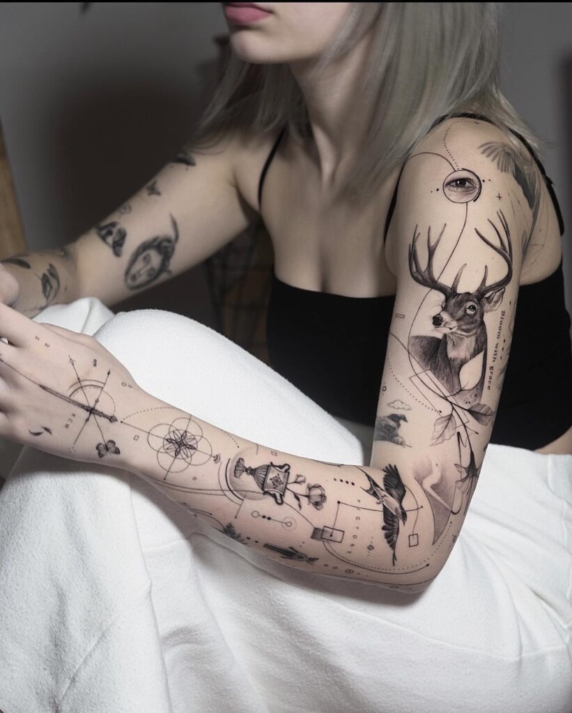 Mystical deer tattoo sleeve with eye, compass, and geometric art