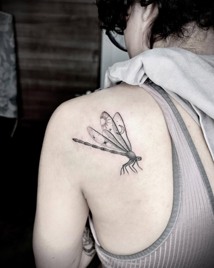 Mystical Dragonfly Tattoo with Celestial Elements on the Shoulder Blade