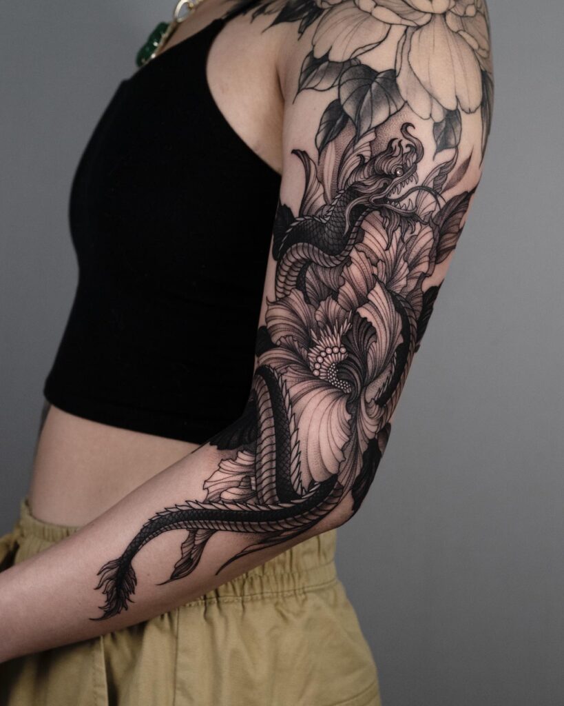 Naga dragon and flower a striking arm and shoulder tattoo for women