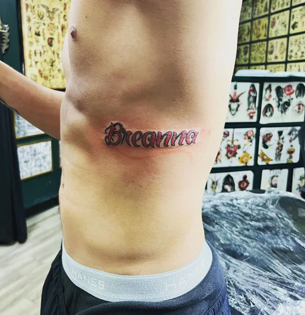 Name tattoo on ribs