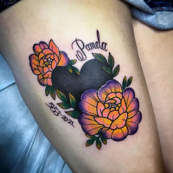 Name tattoo on thigh