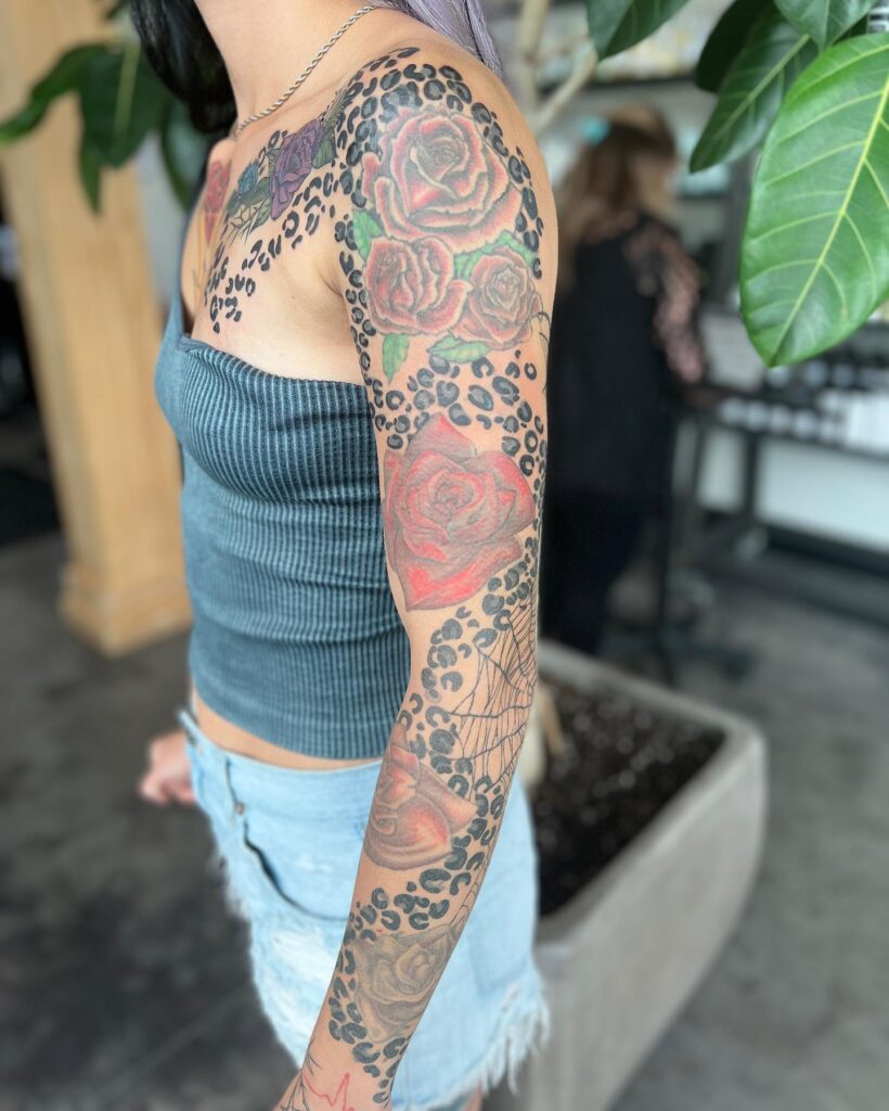 Narrative in ink full sleeve leopard print tattoo with roses