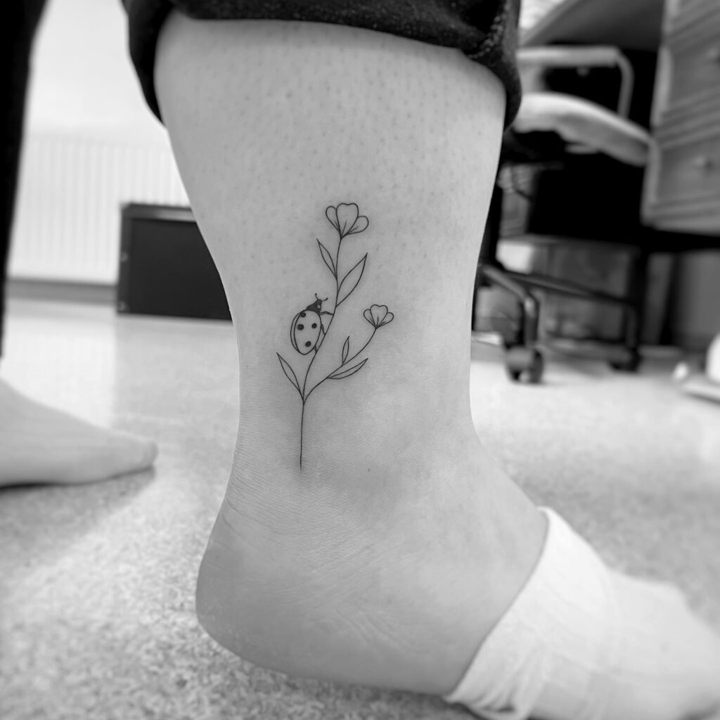 Nature's beauty small flower and ladybug tattoo ankle