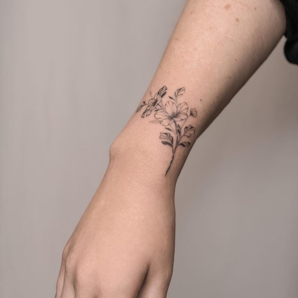 Natures delight small delicate flower tattoo on the wrist