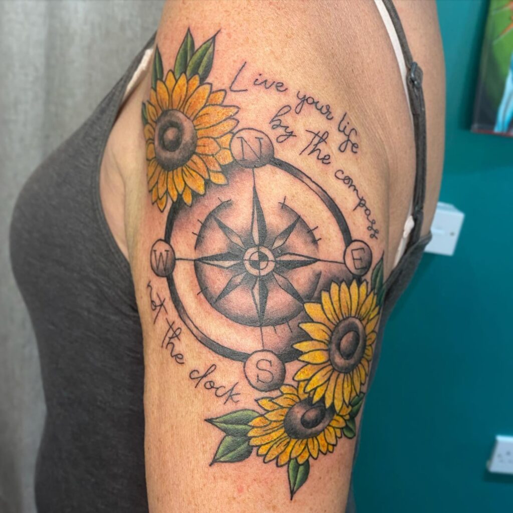 Nature's guidance sunflowers and compass upper arm tattoo