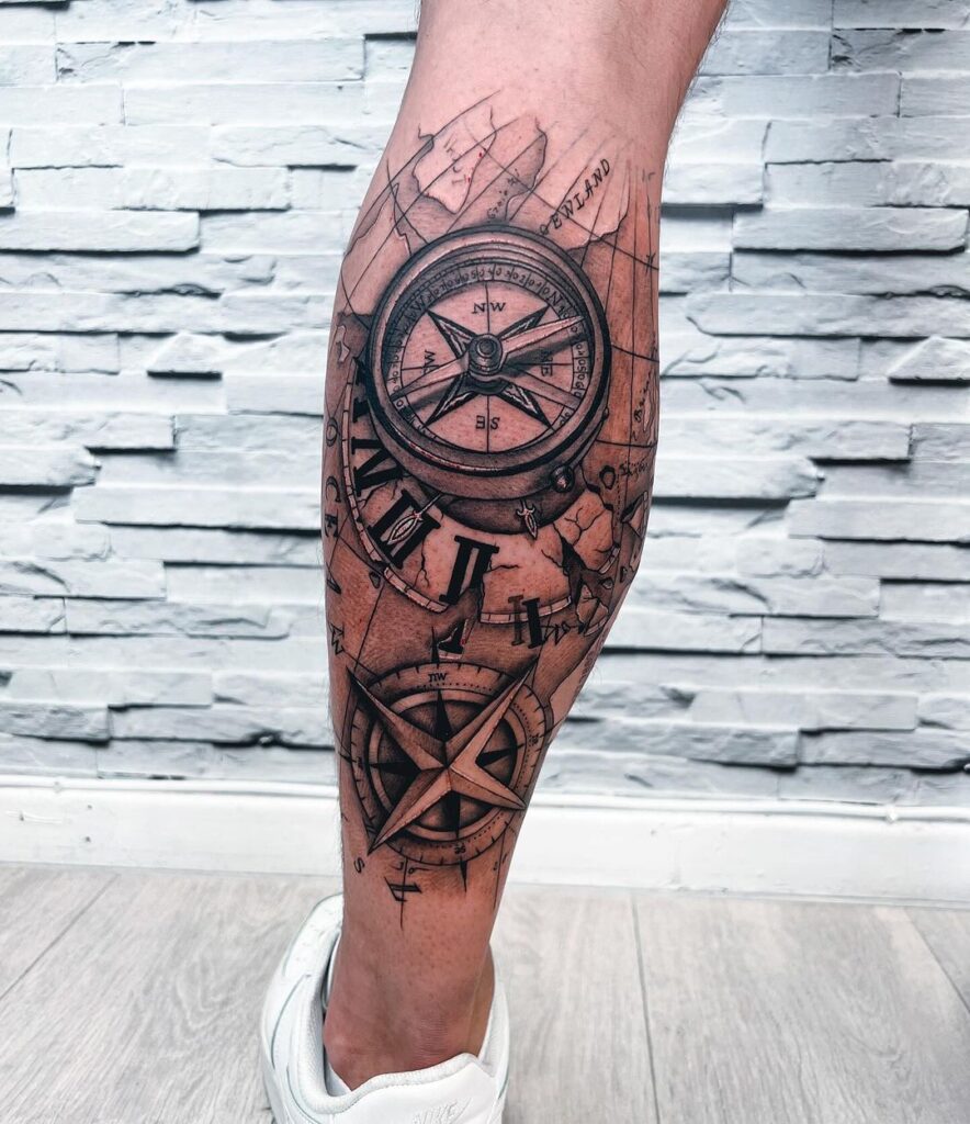 Navigational art compass and map tattoo on the calf