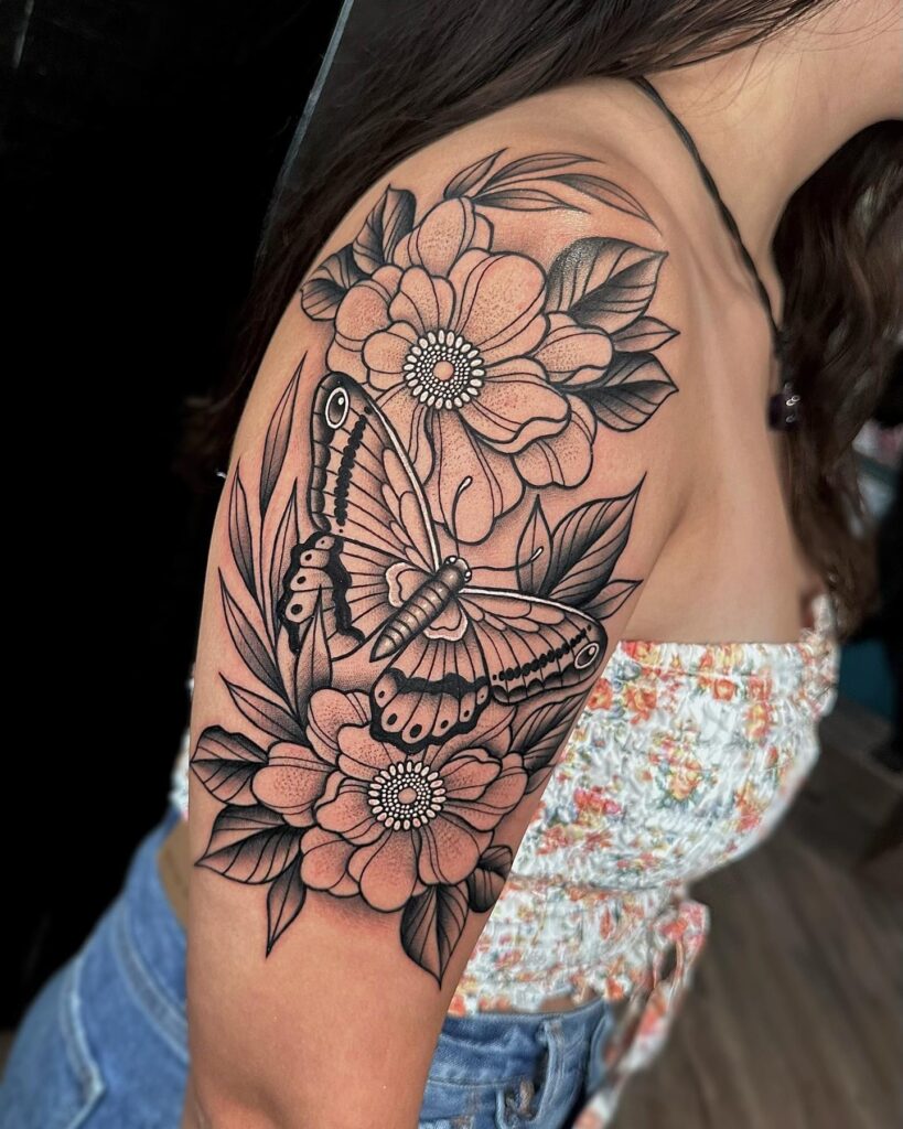 Neo traditional moth with floral upper arm tattoo artistic elegance