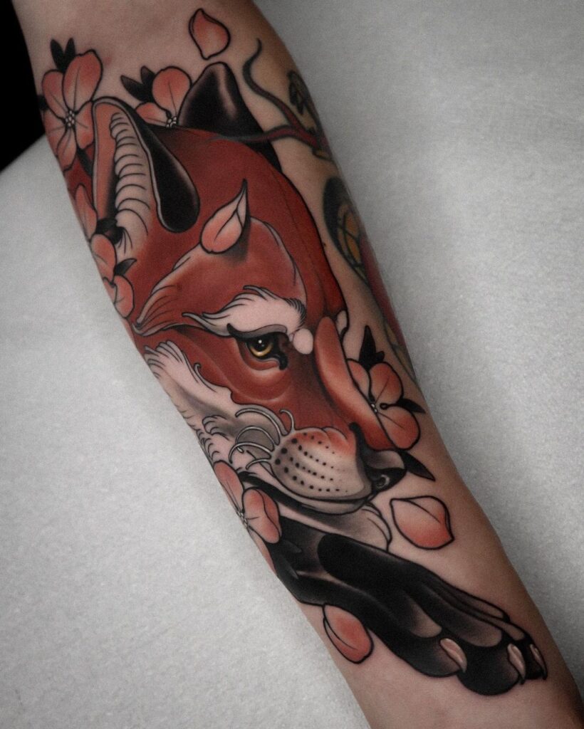 Neotraditional fox tattoo on the forearm vivid with flowers