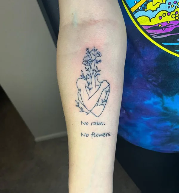 No rain no flowers forearm tattoo