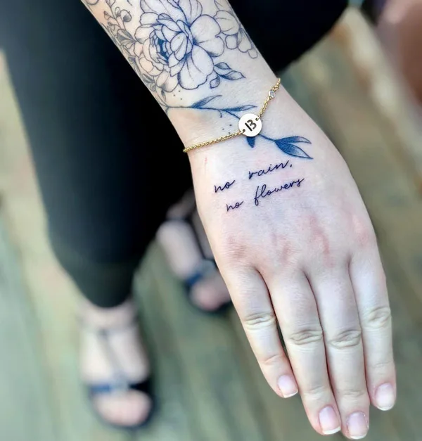 No rain no flowers hand tattoo
