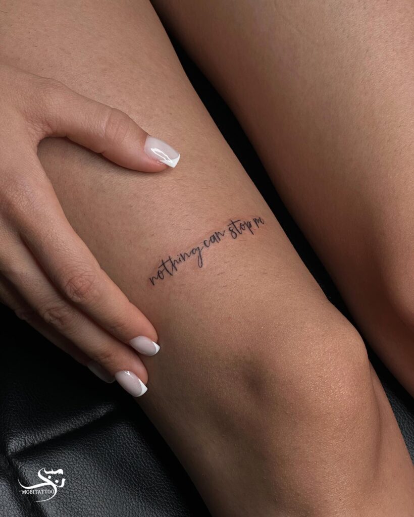 'Nothing Can Stop Me' Text Tattoo Above the Knee: Unstoppable Spirit