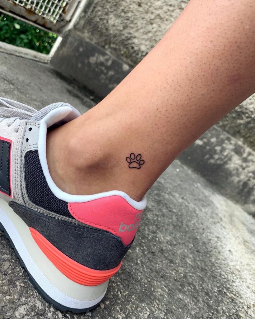 Offbeat elegance vertically tilted outline dog paw near the ankle