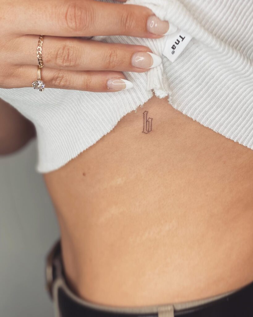 Old english letter b tattoo on the rib: vintage vibe