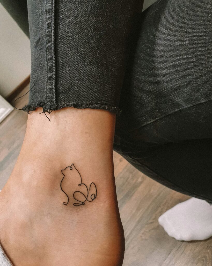 One-Line Dog Sitting Side View Tattoo Near the Ankle: Whimsical Companion