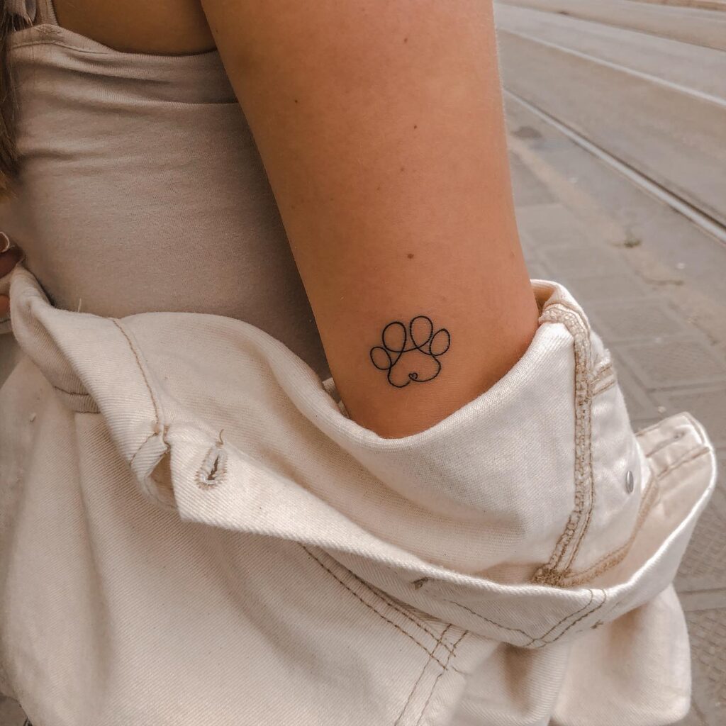 One-Line Paw Print Outline on the Back of the Elbow: Elbow Elegance