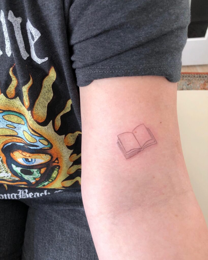 Open Book Tattoo on the Above the Elbow: Literary Charm