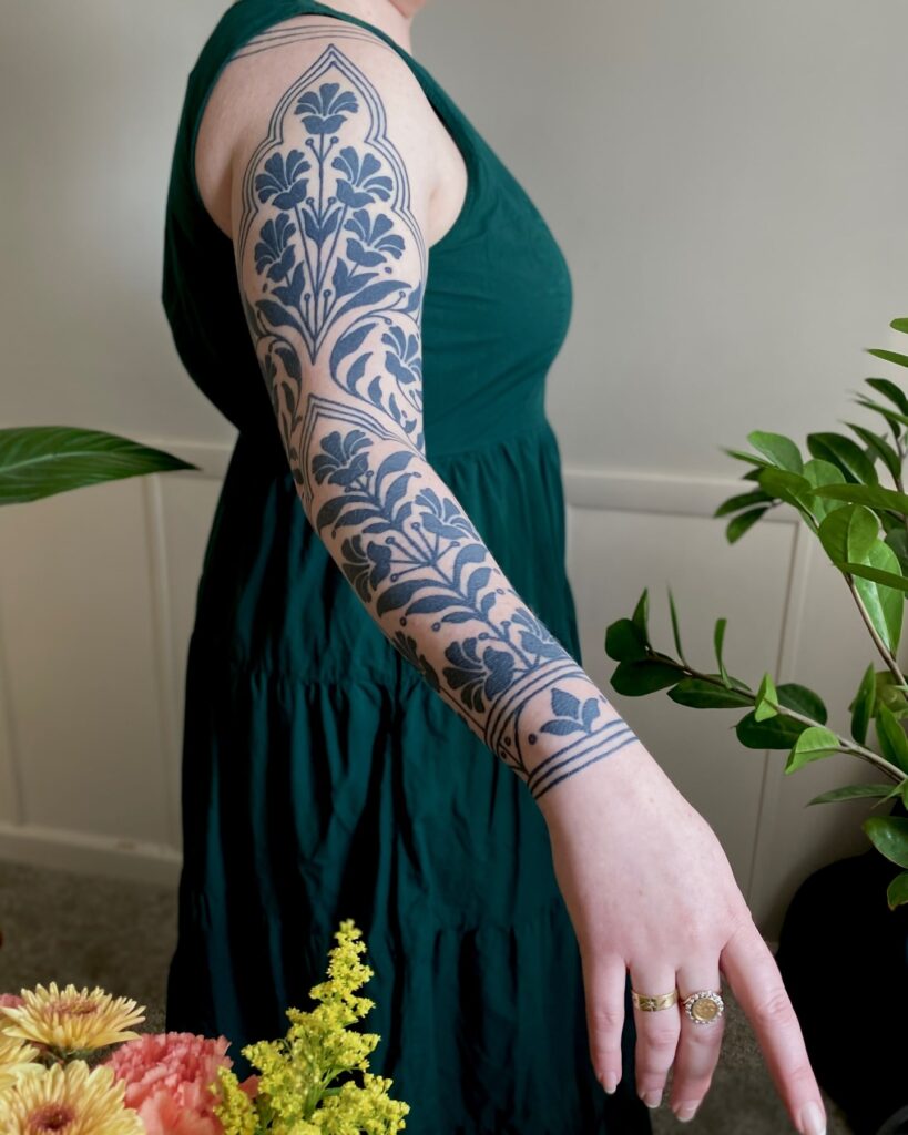 Ornamental Moroccan-inspired floral tattoo sleeve with geometric patterns