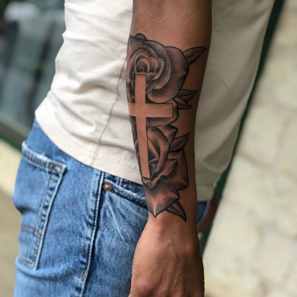 Outer Forearm Cross With Rose Tattoo: Masculine Symbolism