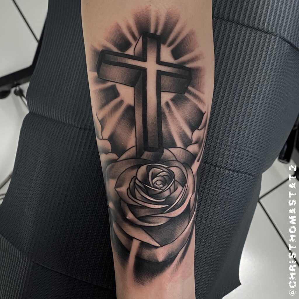Outer forearm cross with rose tattoo for females elegant expression