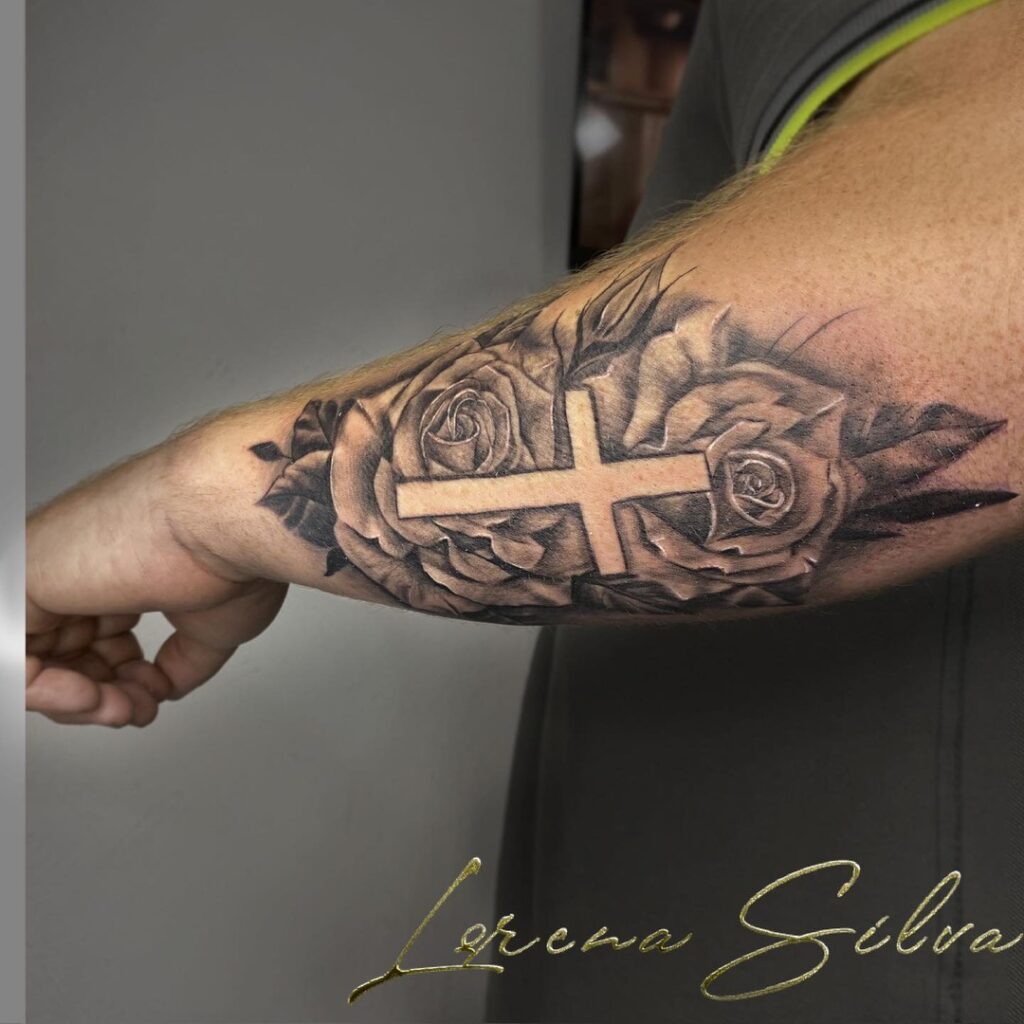 Outer forearm cross with roses tattoo a timeless symbol of faith and beauty