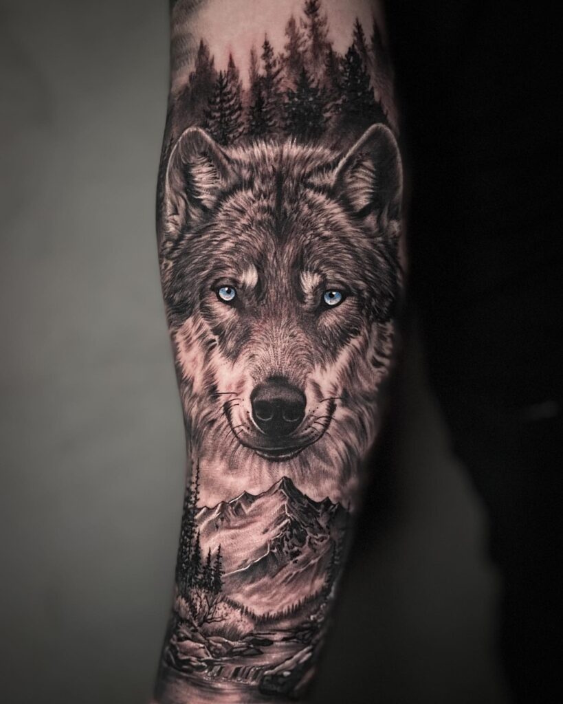 Outer forearm tattoo wonder the forest wolf and mountain scenery
