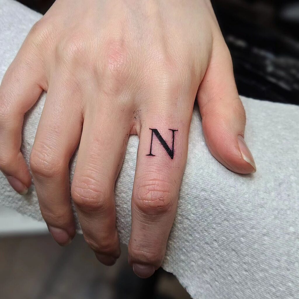 Outer Index Finger Letter 'N' Tattoo: Finger Accent
