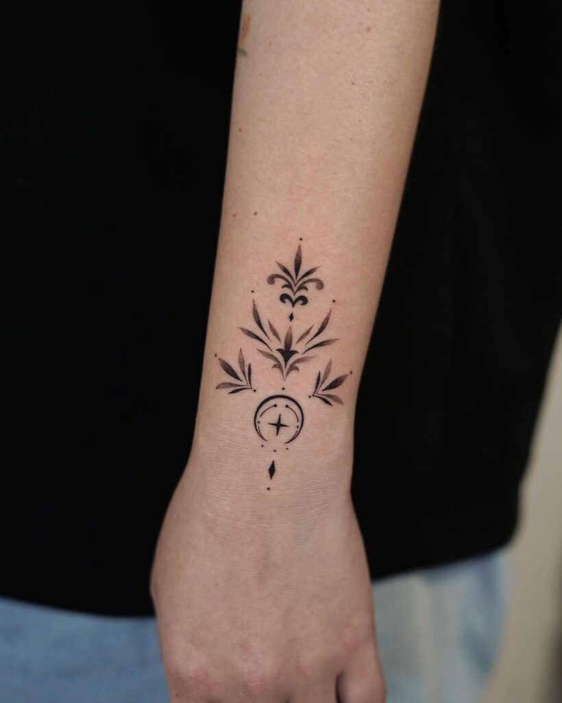 Outer wrist moon ornamental tattoo with black and grey shades
