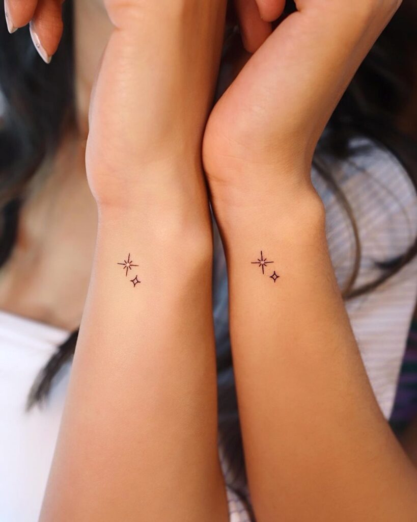 Outer wrist sister tattoo matching stars, one normal, one north star