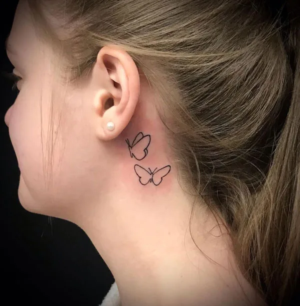 Outline butterfly tattoo behind ear