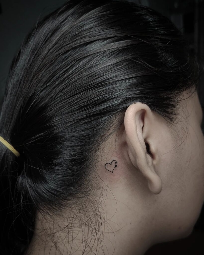 Outline Heart Joined with Semicolon Tattoo Behind the Ear: Connected Hearts
