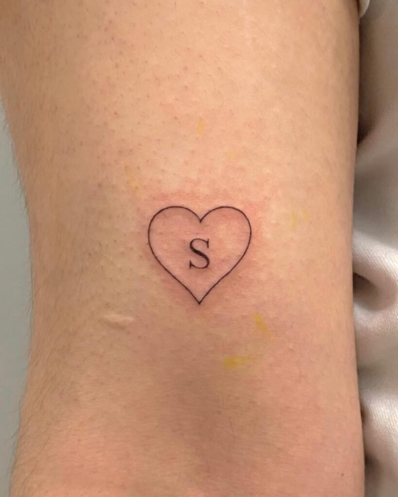 Outline Heart Tattoo Above Elbow with Letter 'S': Heartfelt Symbolism