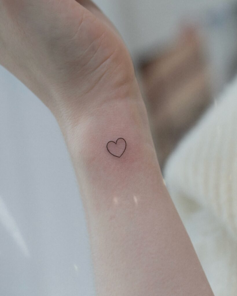 Outline Heart Tattoo on the Side of the Wrist: Mini Love