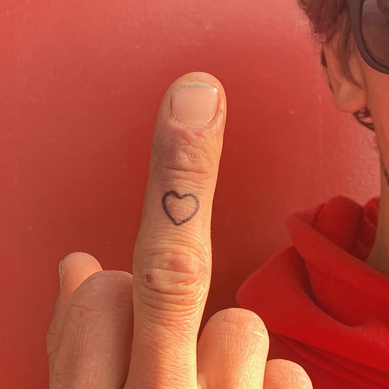 Outline love heart on middle finger men